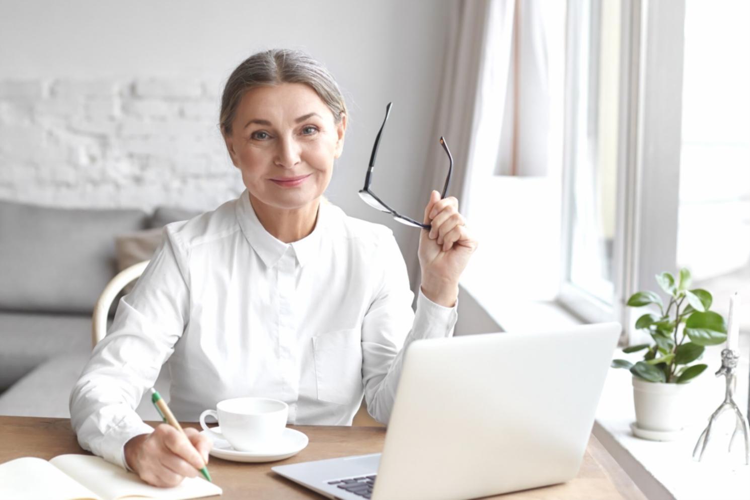Modern workspace with financial planning materials and laptop showing budget analysis